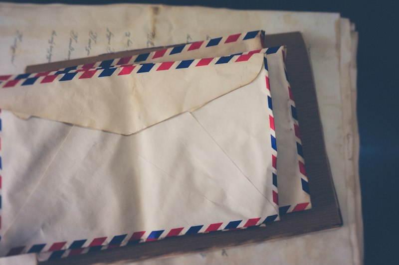 Envelope de carta sendo colocado na caixa de correio
