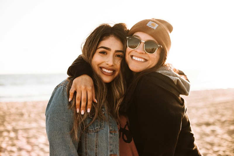 Duas irmãs se abraçando e sorrindo, simbolizando o carinho de uma carta para irmã