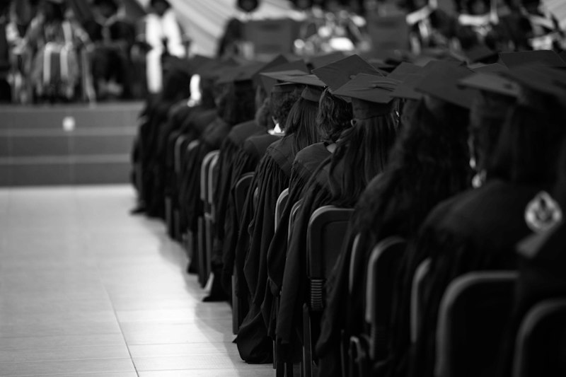 Formando de beca e capelo recebendo mensagem para formandos da família no dia da formatura